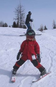Young child downhill skiing.