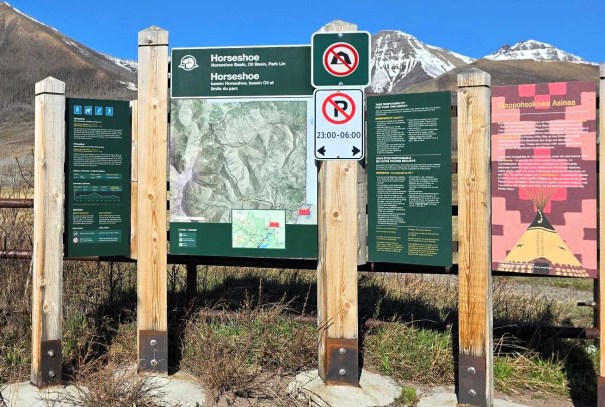 Signage at the Horseshoe Basin trailhead in Waterton National Park, featuring a detailed map, trail regulations, and information about the area.